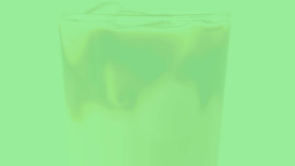 A refreshing iced cappuccino in a clear glass, showing layers of espresso, milk, and frothy foam, with ice cubes, realistic and inviting.