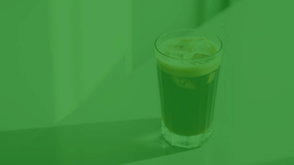A refreshing Italian iced latte with rich espresso and creamy milk poured over ice, served in a clear glass, minimalist presentation, natural lighting, realistic.