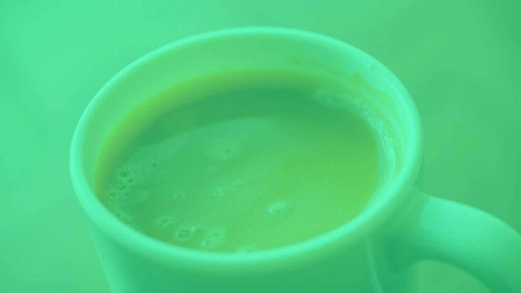A cup of Italian coffee with frothed fior di latte, close-up, velvety texture, warm lighting, realistic.