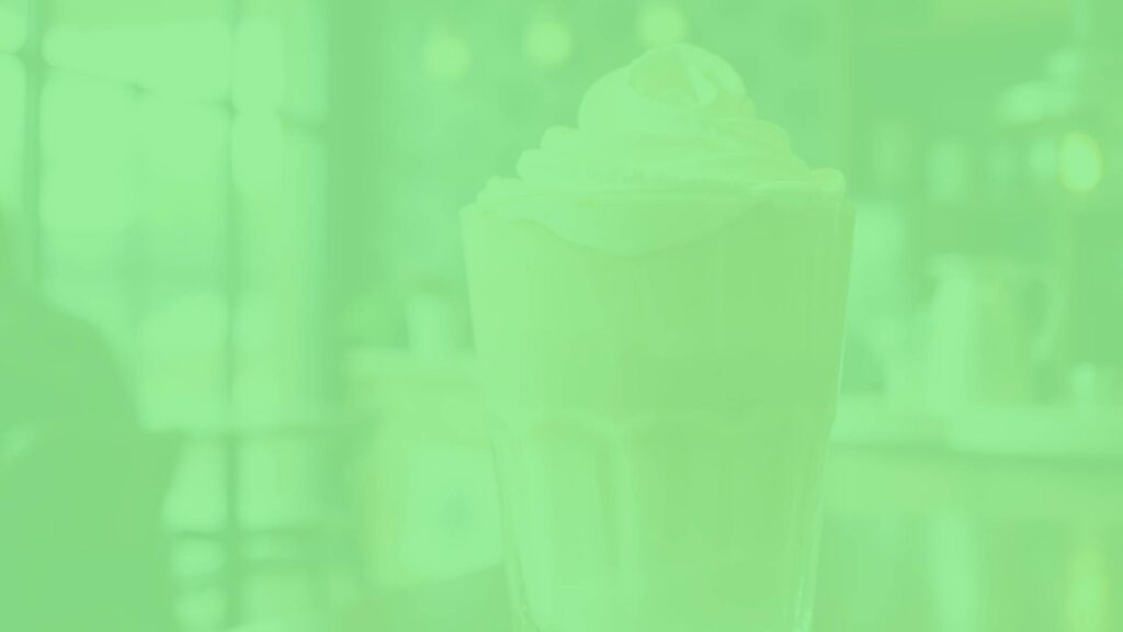 A glass of Dalgona Latte with whipped coffee foam on top, served over ice, creamy texture, visually appealing, warm lighting, cozy coffee shop vibe, realistic.