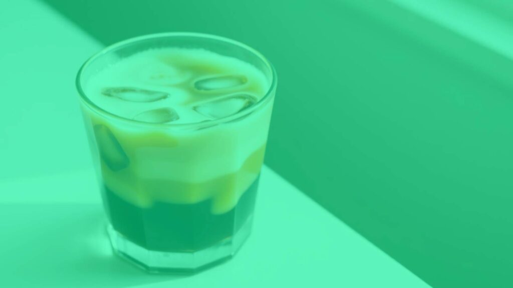 A refreshing cold brew latte in a clear glass, creamy milk swirling with dark coffee, ice cubes, minimalist style, soft natural lighting.
